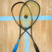 Rocket with ball on beige squash indoor court copy space for promotion